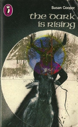 The 1976 cover of Susan Cooper's book "The Dark is Rising". It features a snowy landscape, and within a spotlit circle, a masked rider riding a black horse.  It's giving "Wicker Man for Kids." Book design for kids' literature was a lot edgier back in the day, apparently.