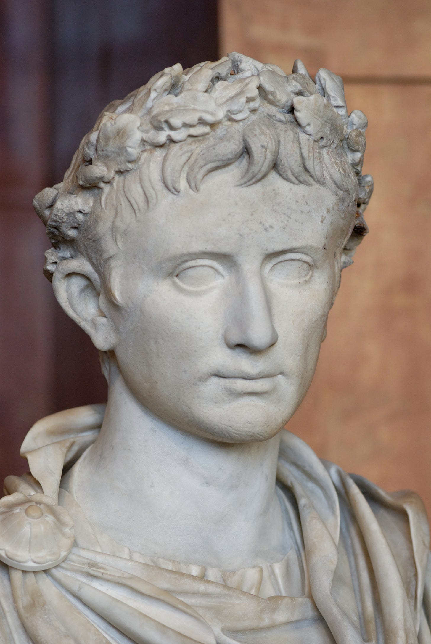 Marble portrait bust of Augustus wearing a laurel wreath, in the Louvre, viewed slightly from the left. Marble portrait bust of Augustus wearing a laurel wreath, in the Louvre, viewed slightly from the left.