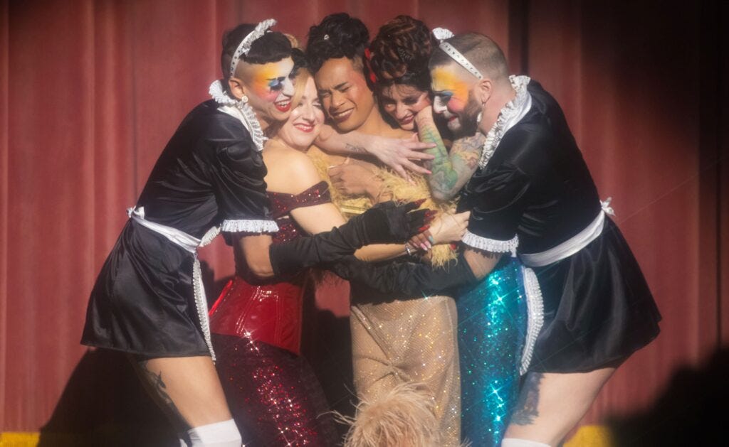 Dollie Award recipient Ariana Amour embraced by Lola Van Ella, Angie Z and stage kittens Dane Baxter and Eddie Lockwood at Teaser Fest, by Chase Stevens Dollie Award recipient Ariana Amour embraced by Lola Van Ella, Angie Z and stage kittens Dane Baxter and Eddie Lockwood at Teaser Fest, by Chase Stevens