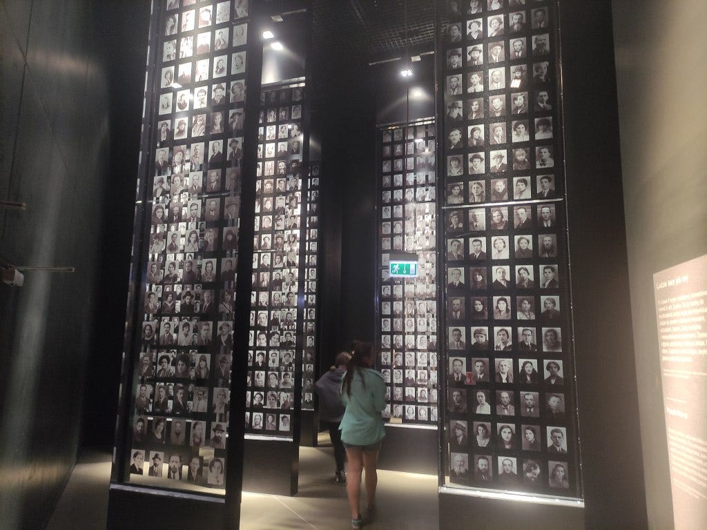 Hanging displays showing headshots of people killed in the Holocaust