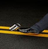 A person's foot stepping on a can on the road

AI-generated content may be incorrect.