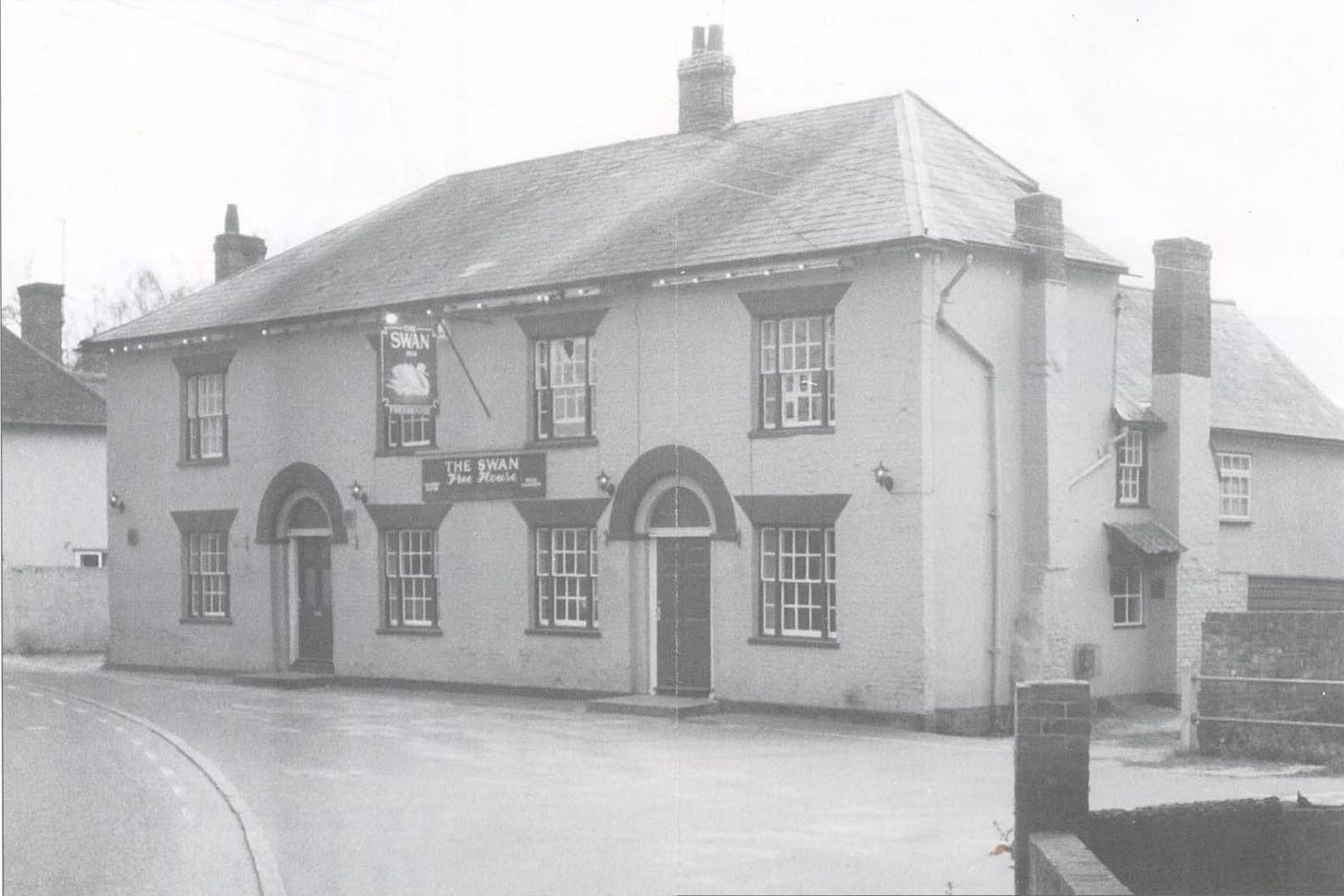 A country pub which appears to be two large semi-detached houses knocked together.