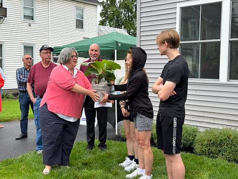 Photos of people at a ribbon cutting, offering gifts to the new homeowners.