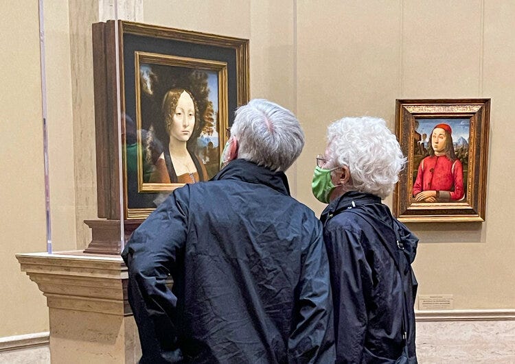 A couple search for finger and palm prints that da Vinci left while using his hands to create surface effects with oil paints that he helped to pioneer in Italy. (Photo: Joseph Kellard)