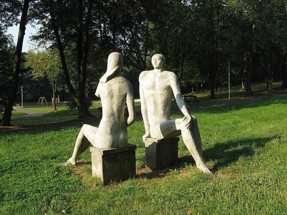 A statue of two people sitting on a bench

AI-generated content may be incorrect.