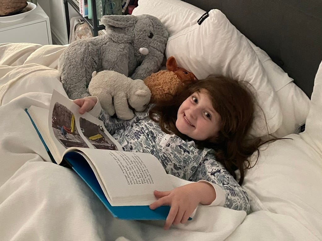 Reading in bed. Kid. Stuffed Animals.