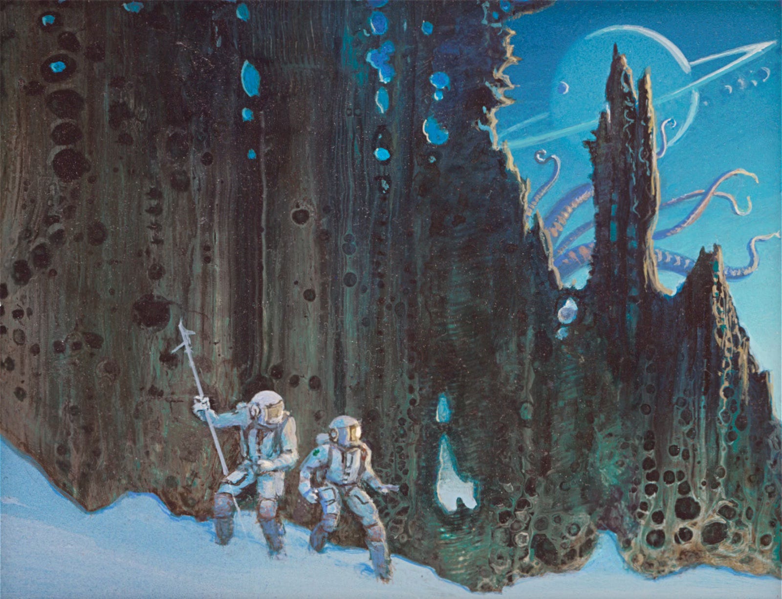 Two astronauts in spacesuits and helmets navigate the snowy slope of an alien planet back by an enormous wall of rock riddled with shadowy holes. In the upper right, the rock gives way to a blue sky with a ringed planet looming with a handful of rock chunks in orbit. Long pale purple tentacles tease out from the rock.