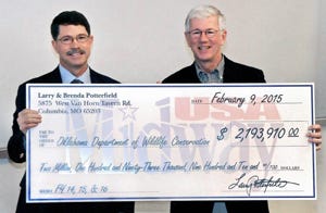 Richard Hatcher, director of the Oklahoma Department of Wildlife Conservation, and Larry Potterfield, founder of MidwayUSA Inc., hold a symbolic check for more than $2.1 million, representing the total money donated over three years by MidwayUSA Foundation and the Potterfield family for the Oklahoma Scholastic Shooting Sports Program. Richard Hatcher, director of the Oklahoma Department of Wildlife Conservation, and Larry Potterfield, founder of MidwayUSA Inc., hold a symbolic check for more than $2.1 million, representing the total money donated over three years by MidwayUSA Foundation and the Potterfield family for the Oklahoma Scholastic Shooting Sports Program.