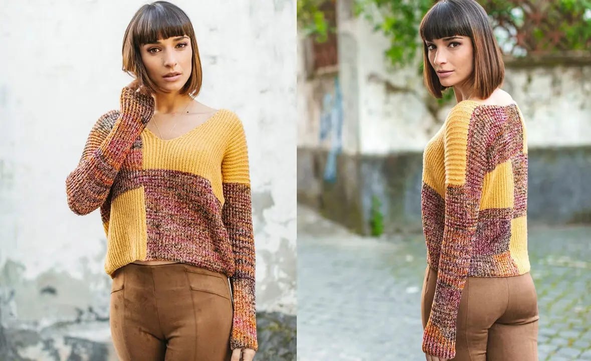 short-haired woman standing on street wearing a yellow and red knitted sweater