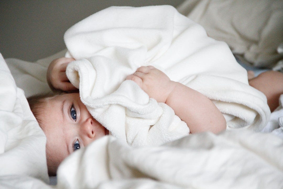 baby laying on bed baby laying on bed