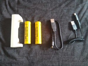 Left to right: ML-102 18650 charger can charge any USB device, two 18650 batteries, my Micro USB cable, and a Mini USB cable for charging the batteries Left to right: ML-102 18650 charger can charge any USB device, two 18650 batteries, my Micro USB cable, and a Mini USB cable for charging the batteries