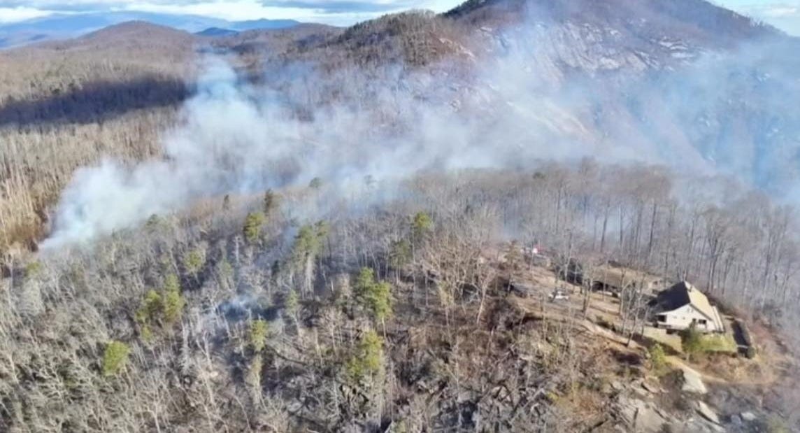 May be an image of fire, mountain, tree and fog May be an image of fire, mountain, tree and fog