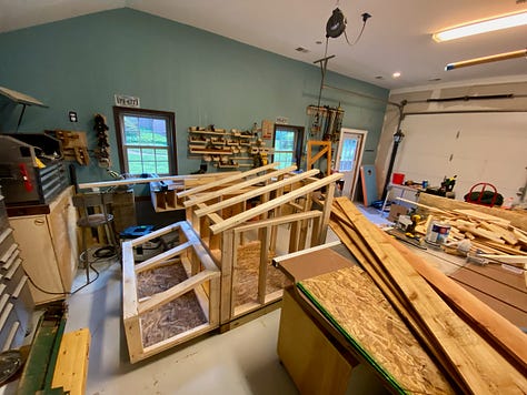 Chicks, ducks, and a duck coop being constructed.