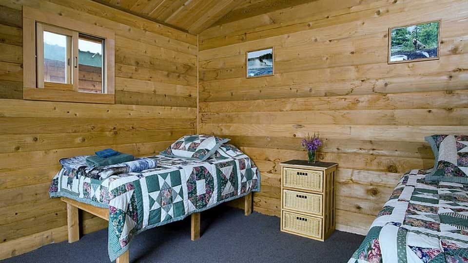 Quilts on Bunk Beds in Wood-paneled room
