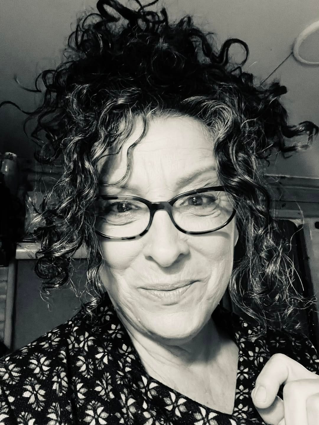 May be a black-and-white image of one or more people, people smiling and eyeglasses