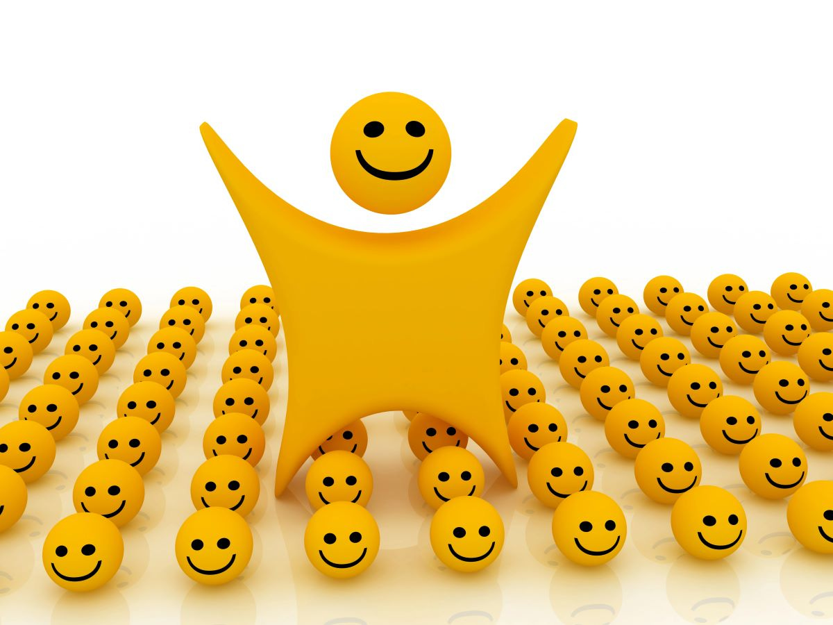 Smiley person, arms raised, standing in rows of smiley balls