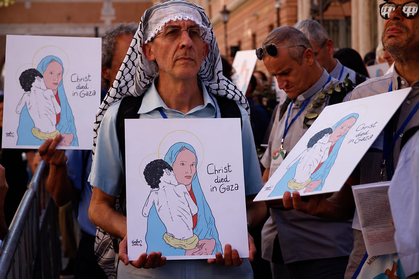 A marcher holds a “Christ died in Gaza” placard near the Vatican A marcher holds a “Christ died in Gaza” placard near the Vatican