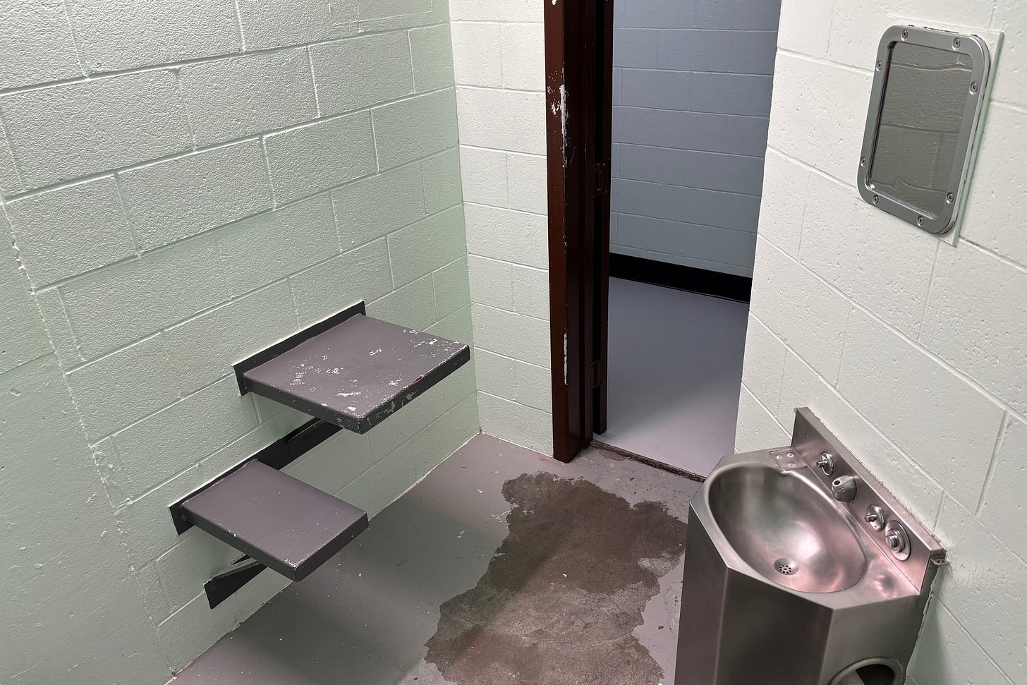 An interior of a small prison cell. An interior of a small prison cell.