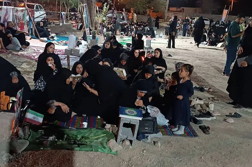 Motherss sit at graves of children in Iran