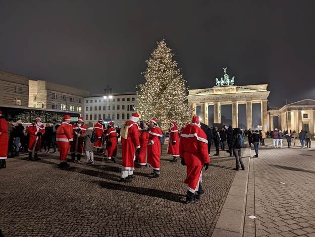 A group of people in red and white outfits in front of a large building

AI-generated content may be incorrect.
