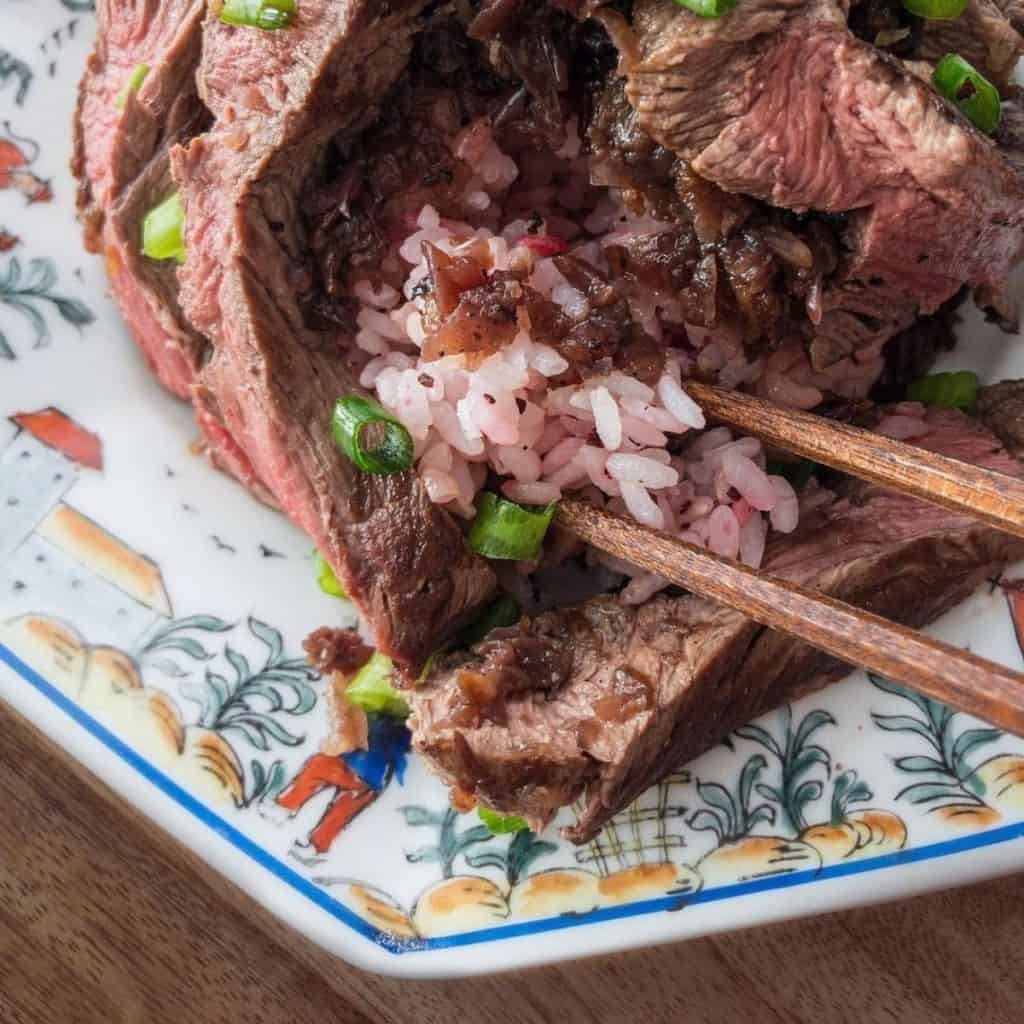 Tender beef in onion marinade sauce served with rice