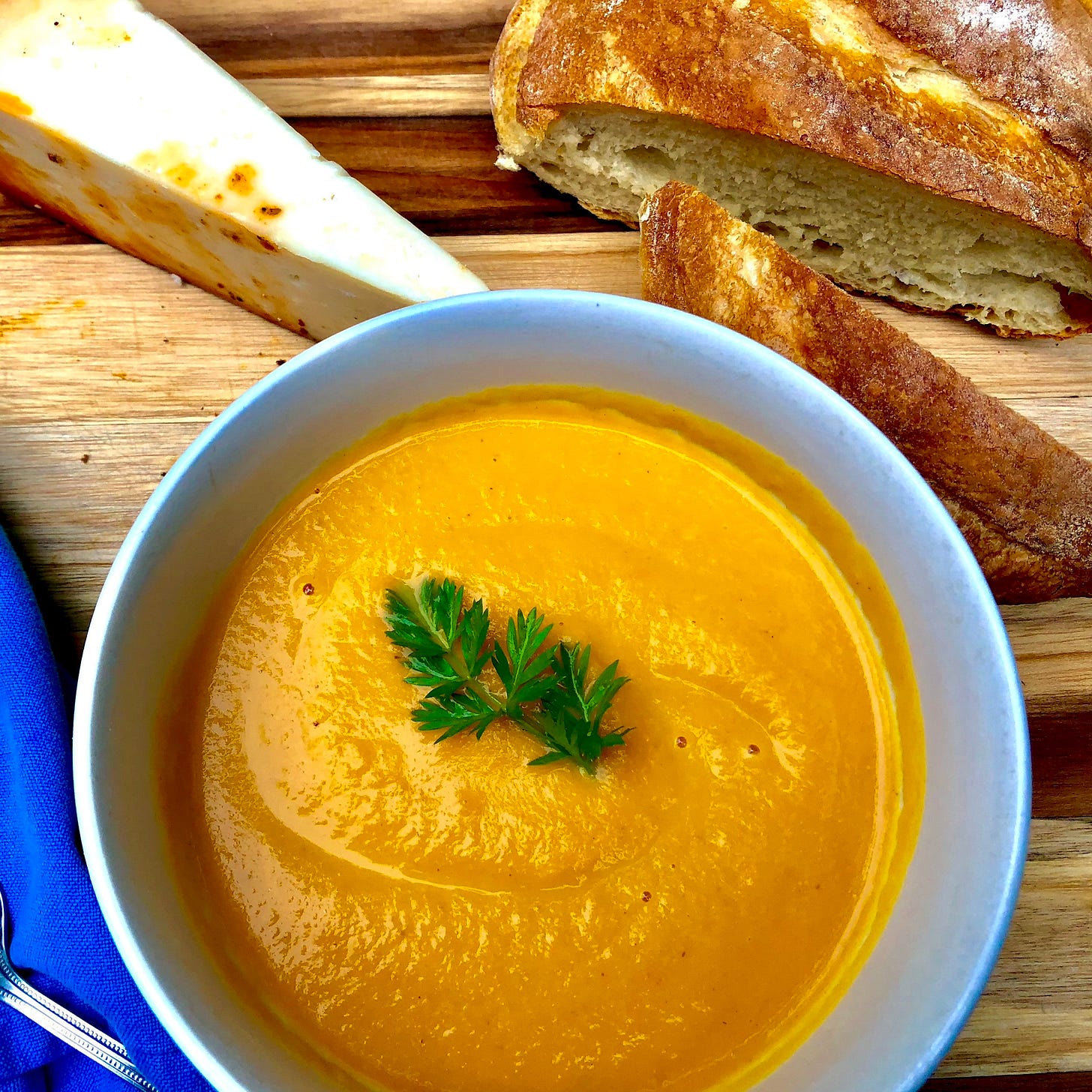  served here with fresh artisan bread, TJ’s chipotle toscano cheese, and garnished with the edible carrot tops. 