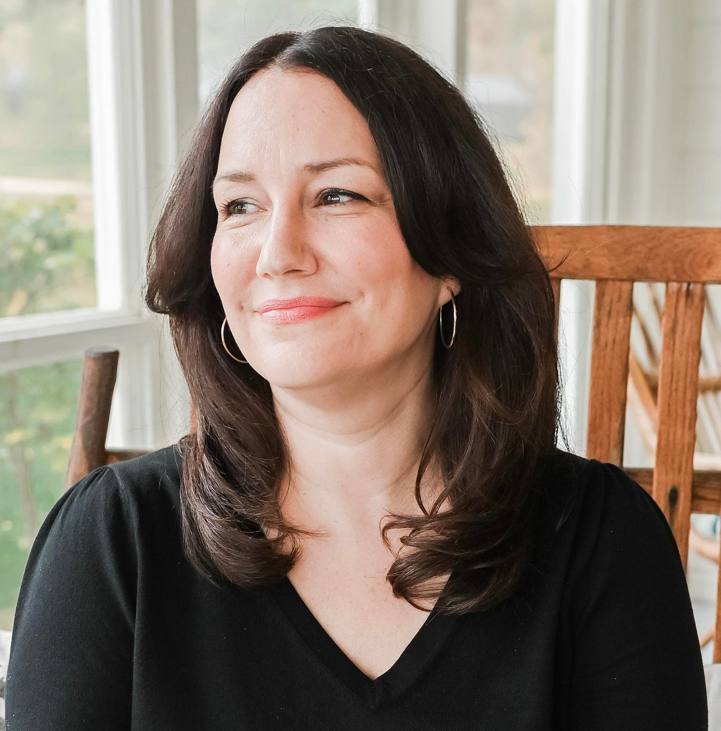 A woman looking to the side and smiling A woman looking to the side and smiling