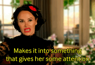 a woman with a red flower in her hair says makes it into something that gives her some attention