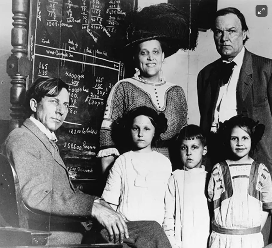 Job Harriman, left, and Clarence Darrow (right) with Mrs. Ortie McManigal and her children. Another bombing conspirator, McManigal confessed before the McNamaras.