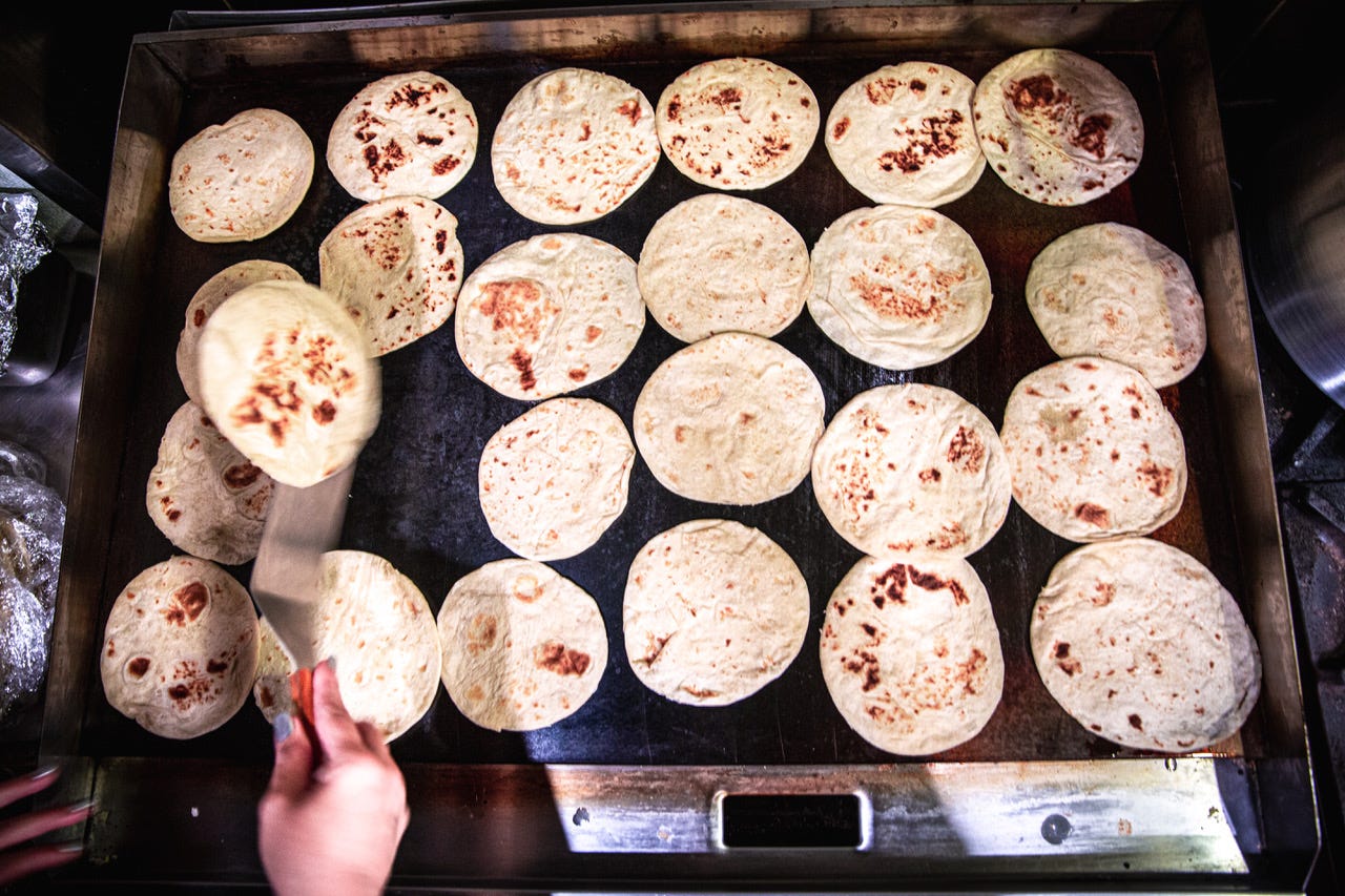 A griddle full of tortillas
