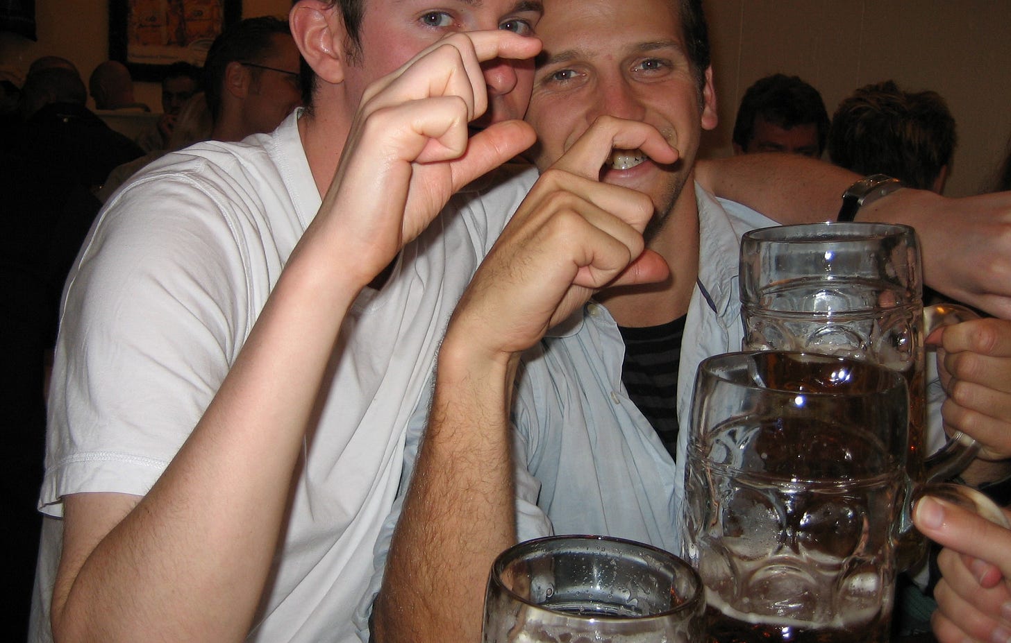friends at Oktoberfest with beer mugs