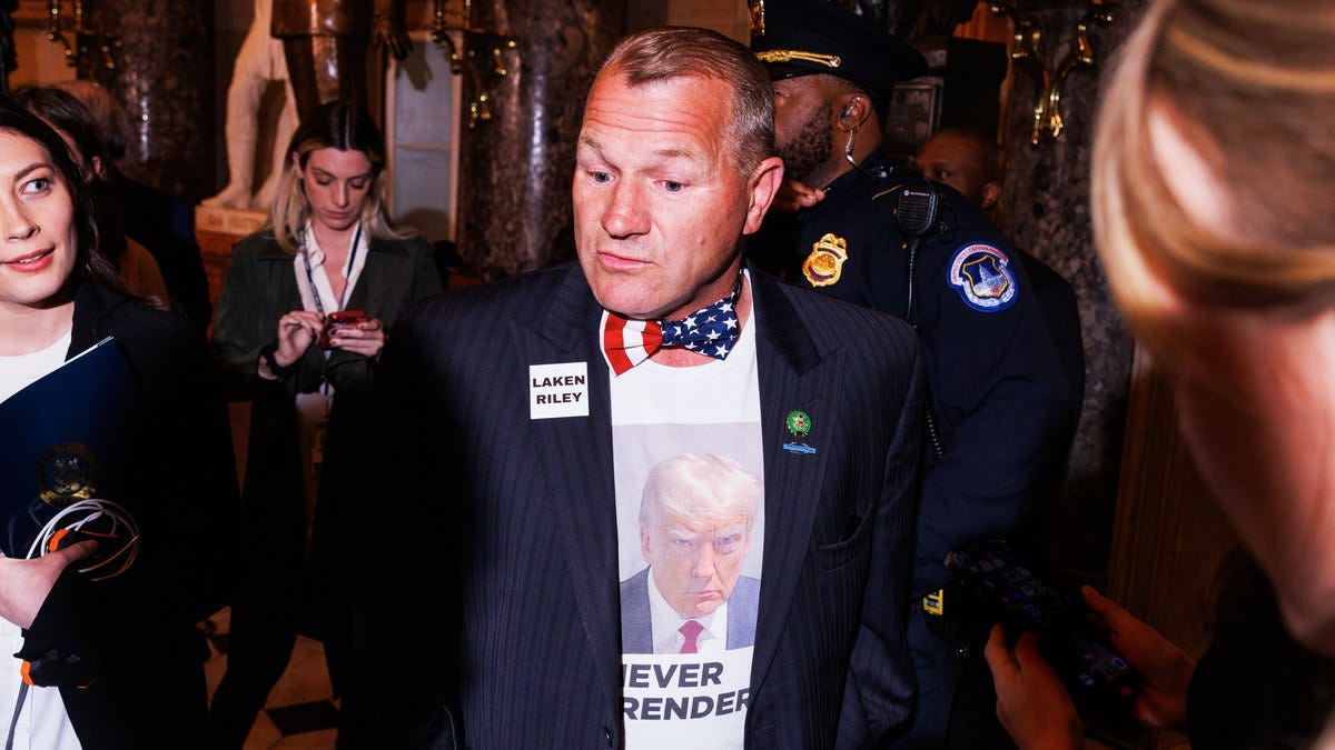 A person in a suit with a picture of a person in a bow tie

Description automatically generated
