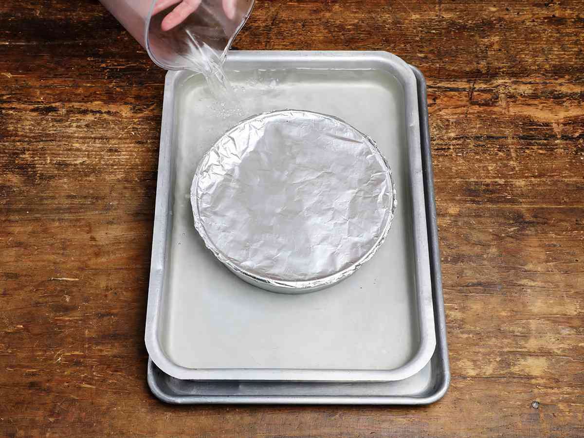 placing flan in bain Marie placing flan in bain Marie