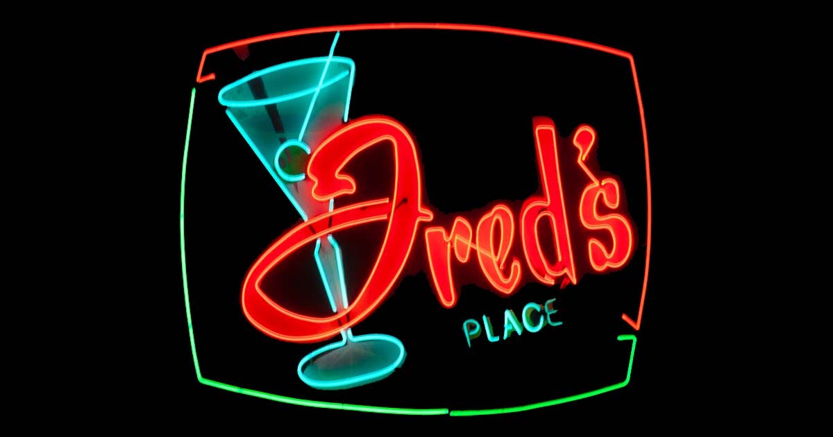 A neon bar sign reading Fred's Place