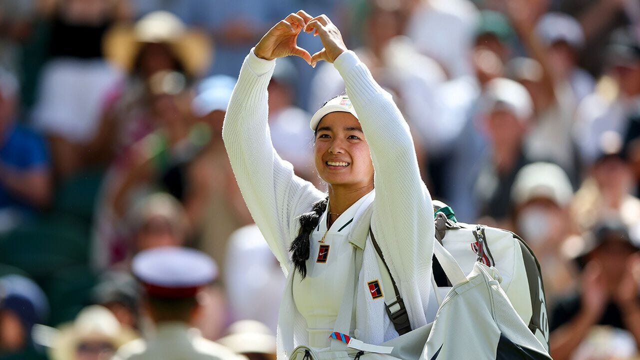 Alexandra Eala acknowledges the crowd with a love heart gesture