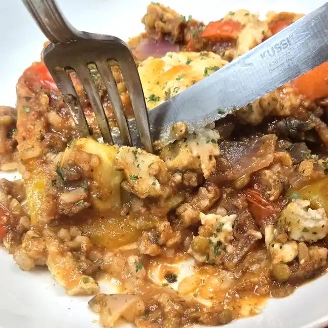 A Fork and knife cutting a bite of Unstuffed Peppers Casserole