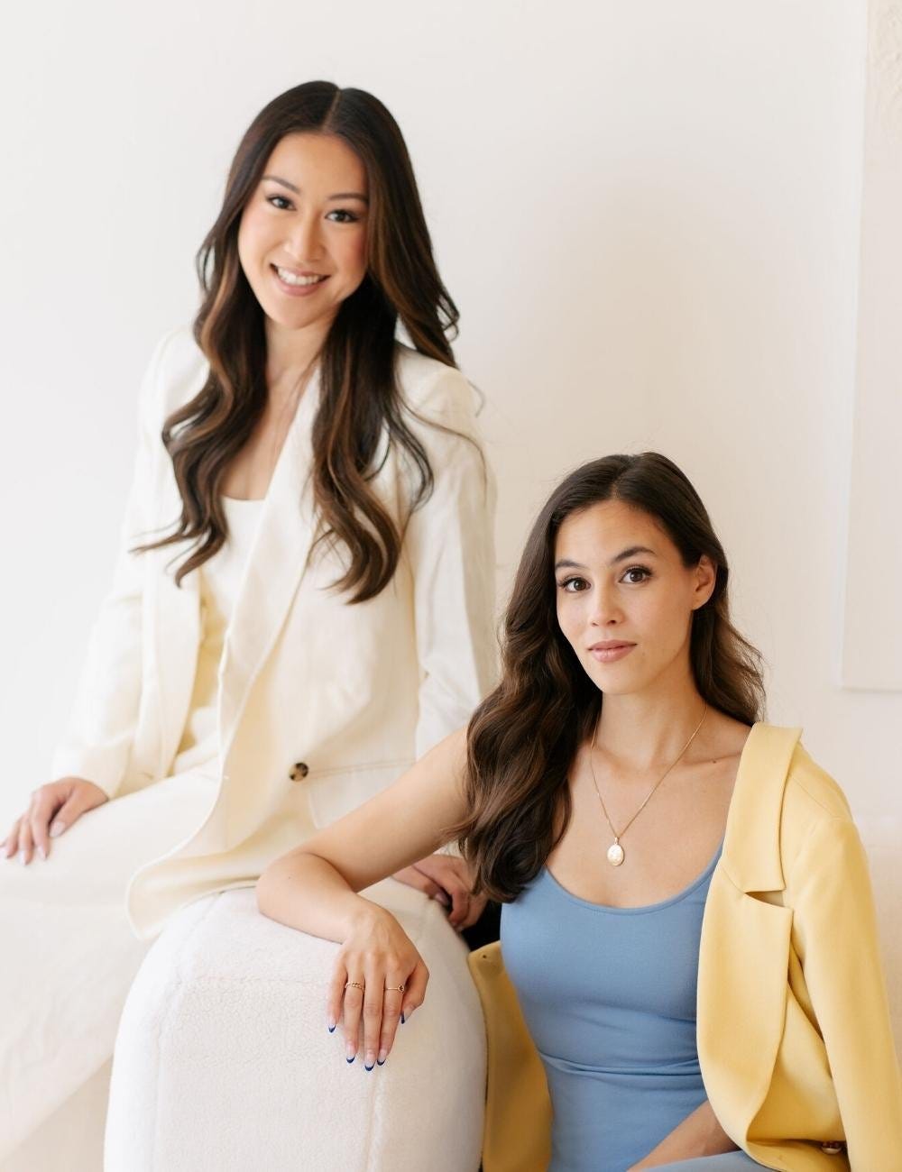 Two women smiling at a camera in a professional headshot.