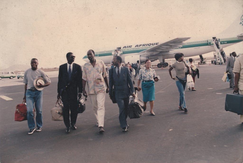 Basile Boli, Pape Diouf and Mody Diop disembarking from an air afrique plane and walking across the tarmac like they own it, in the early 1990s, although judging by the light-brown haze to could equally be the 1970s.