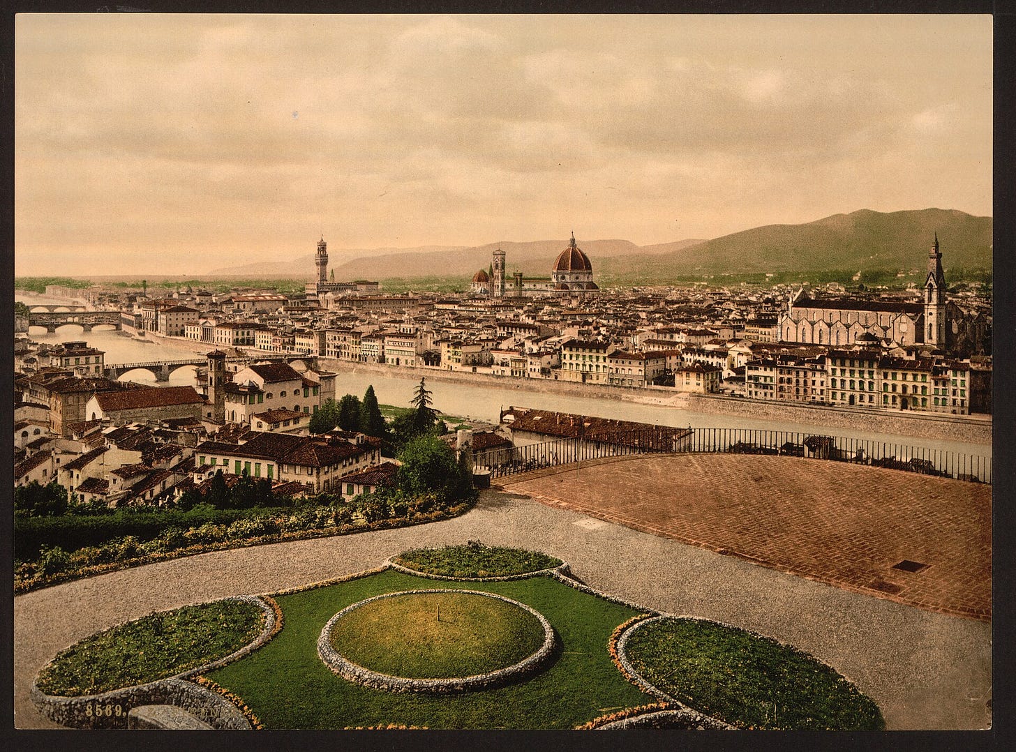 Old color photograph of Florence's rooftops with the huge red brick dome of the cathedral rising above the city, the bell tower beside it. Old color photograph of Florence's rooftops with the huge red brick dome of the cathedral rising above the city, the bell tower beside it.