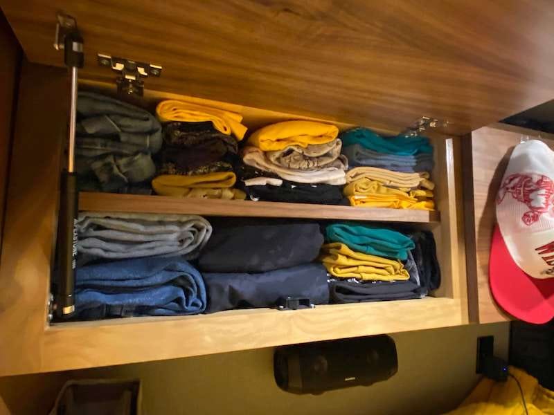 Our above bed clothes cabinet in our converted camper van