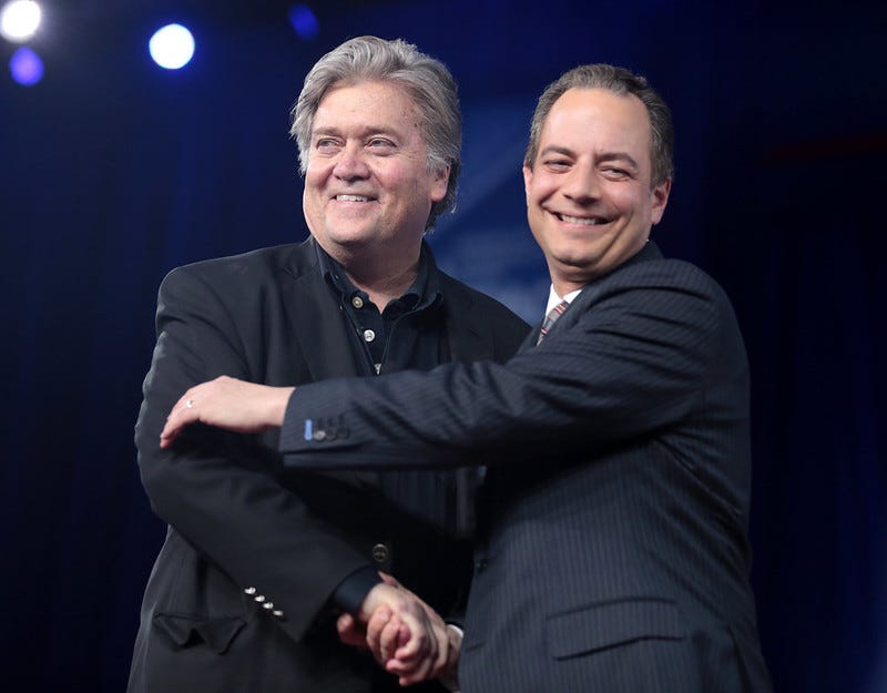 Bannon and Priebus embracing on stage