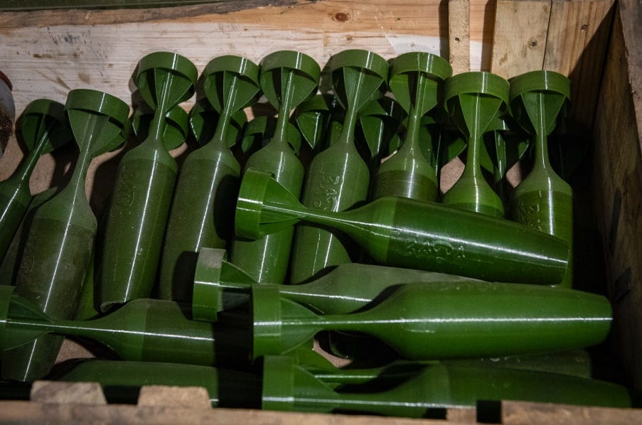 A group of green objects in a wooden box

AI-generated content may be incorrect.