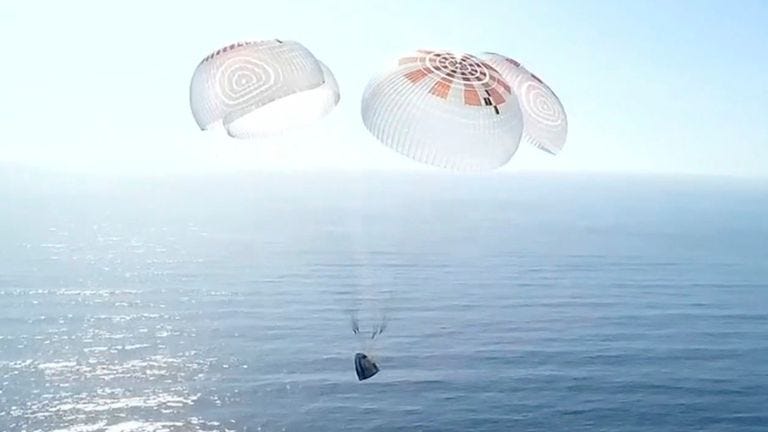 In this image from video provided by SpaceX, a Dragon capsule carrying four space tourists prepares to splash down in the Pacific Ocean off the coast of California on Friday, April 4, 2025. (SpaceX via AP)