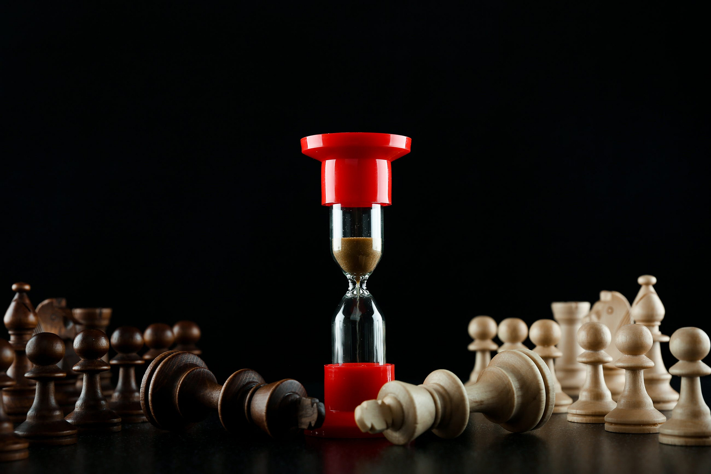 an hourglass on a chessboard next to the fallen kings. time spares no one. the time is the same for everyone By Петр Смагин on AdobeStock licensed. an hourglass on a chessboard next to the fallen kings. time spares no one. the time is the same for everyone By Петр Смагин on AdobeStock licensed.