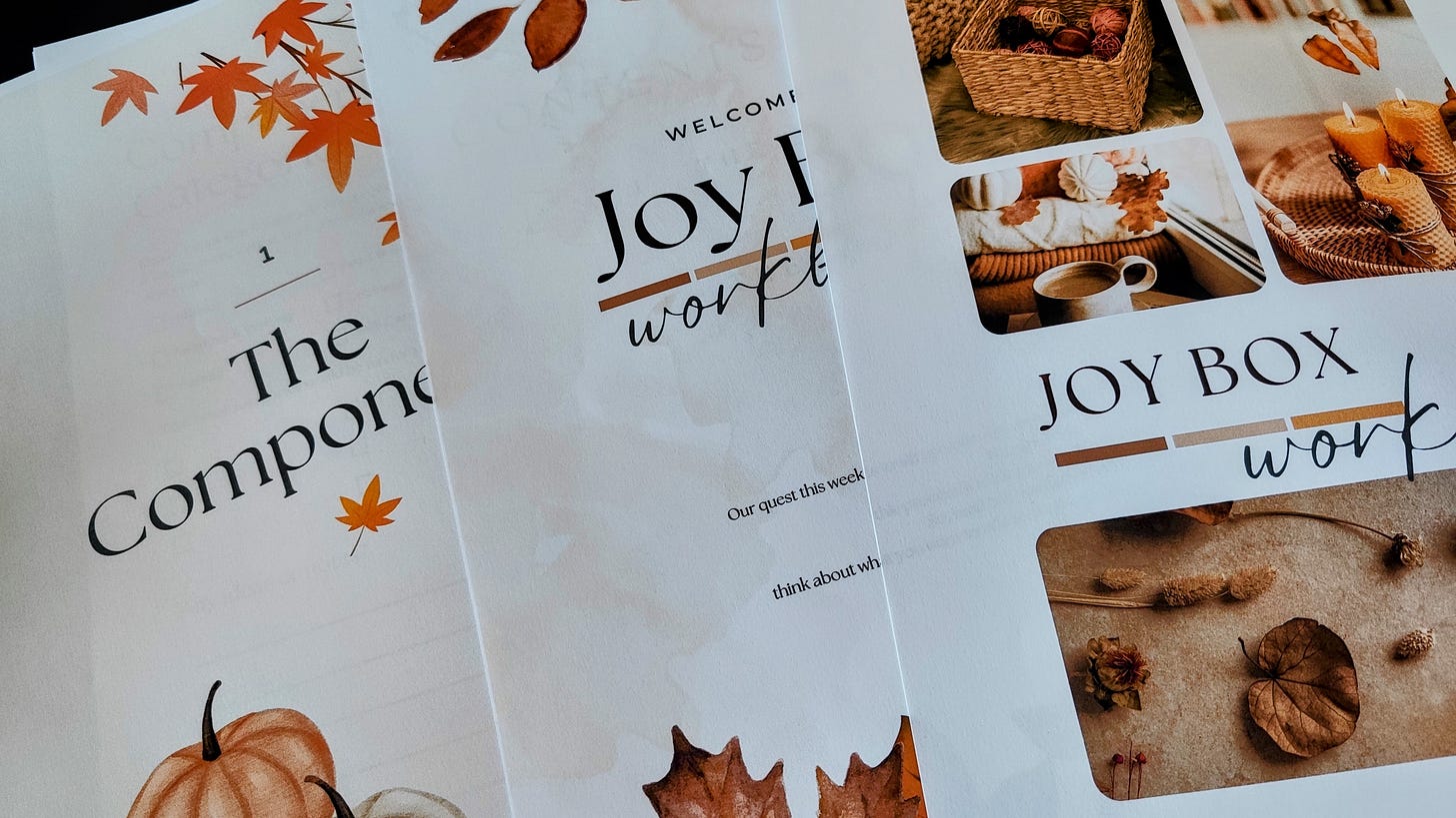 Close-up of three printed pages with pretty autumn themed decorations — pumpkins, fallen leaves, etc.