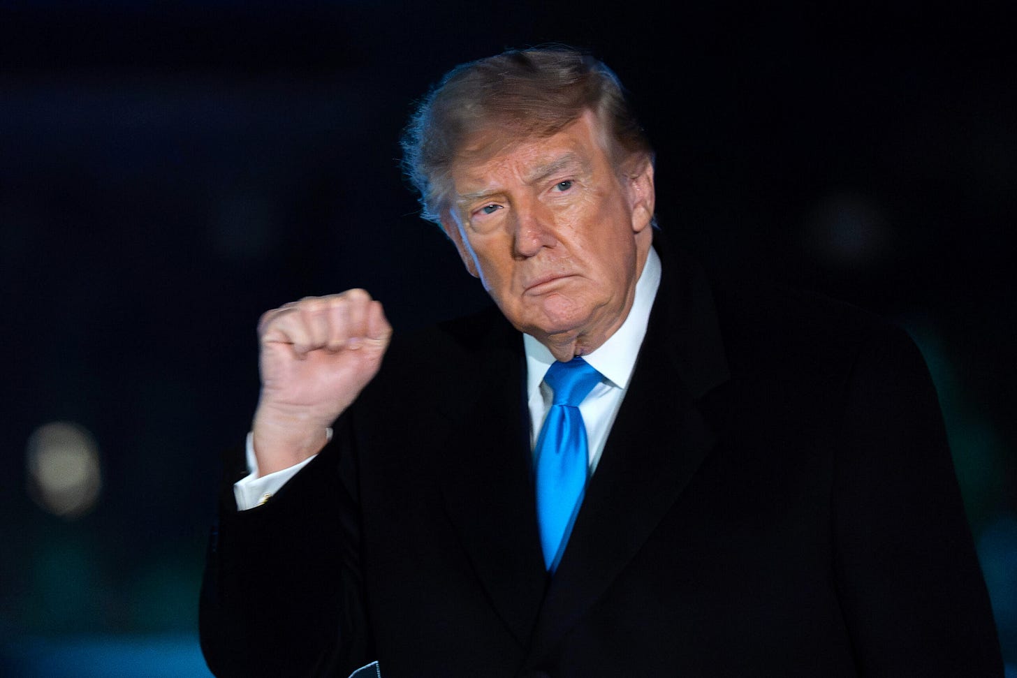 President Donald Trump raises a fist outside the White House President Donald Trump raises a fist outside the White House
