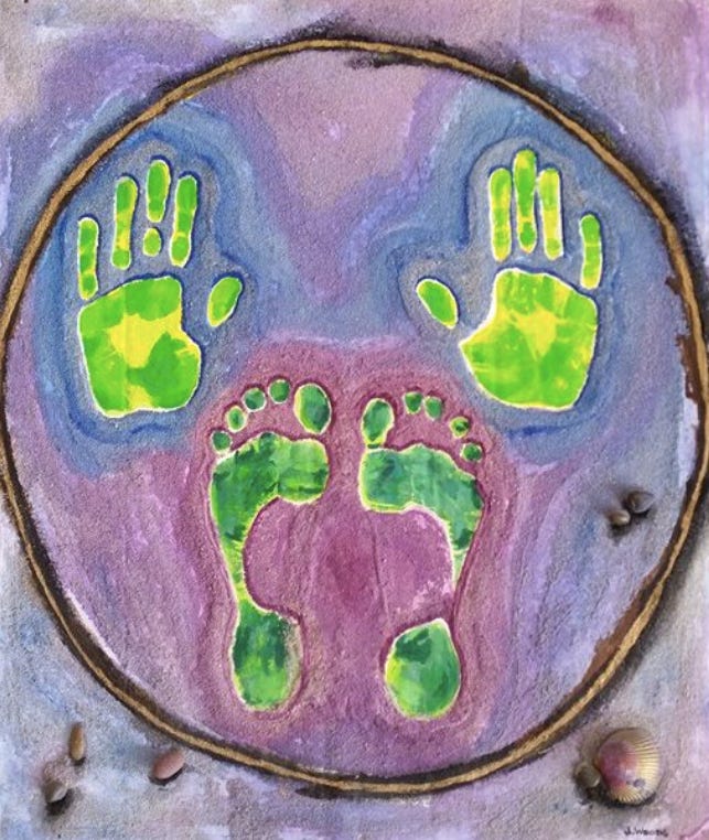 A mixed media painting of hand and foot prints within a circle by Juliette Jarvis