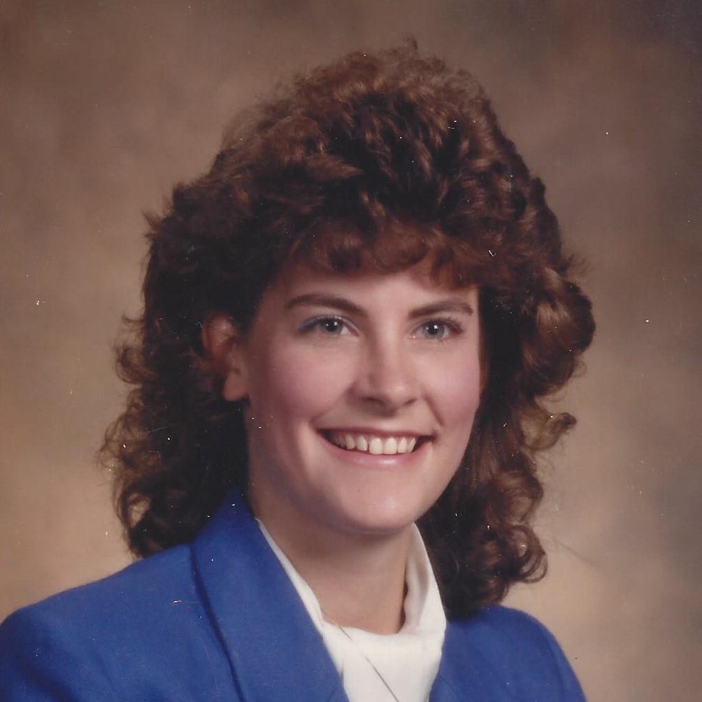 Eager young woman in a business suit looks ready to take on the world in her business suit