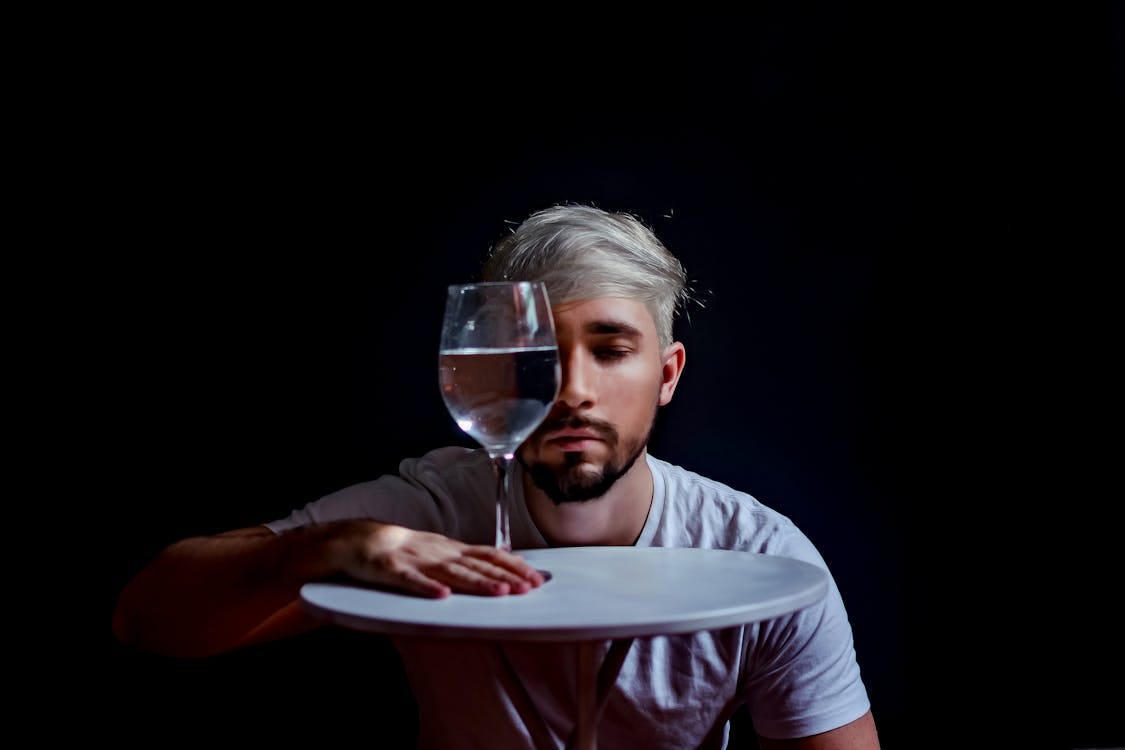 Free Creative portrait of a man with glass reflection, creating an abstract effect. Stock Photo