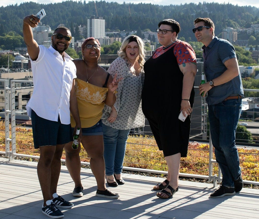 five people standing near railings